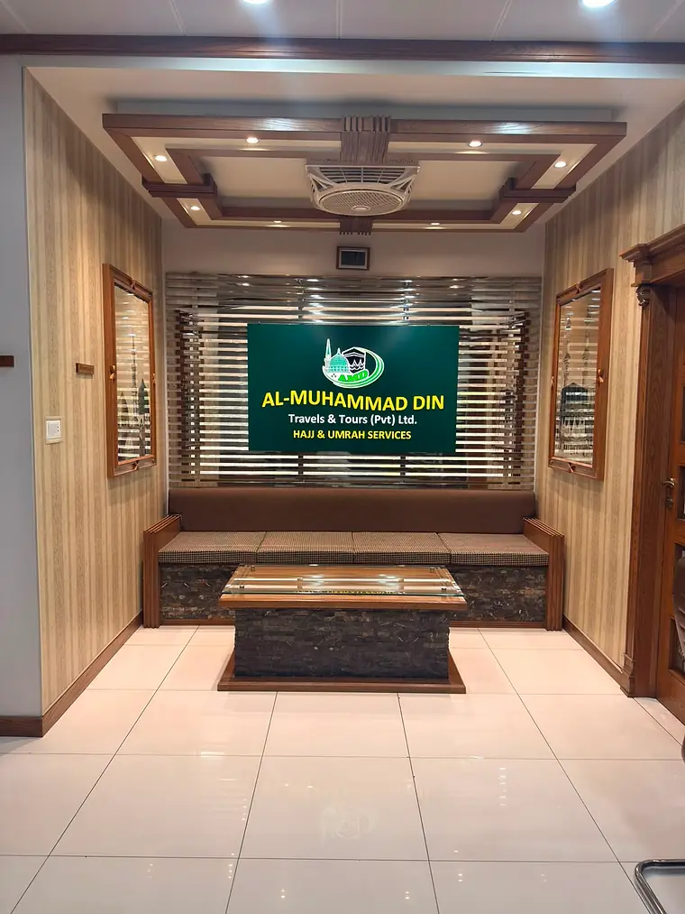 The reception room inside the office, with seating and the company sign on the wall